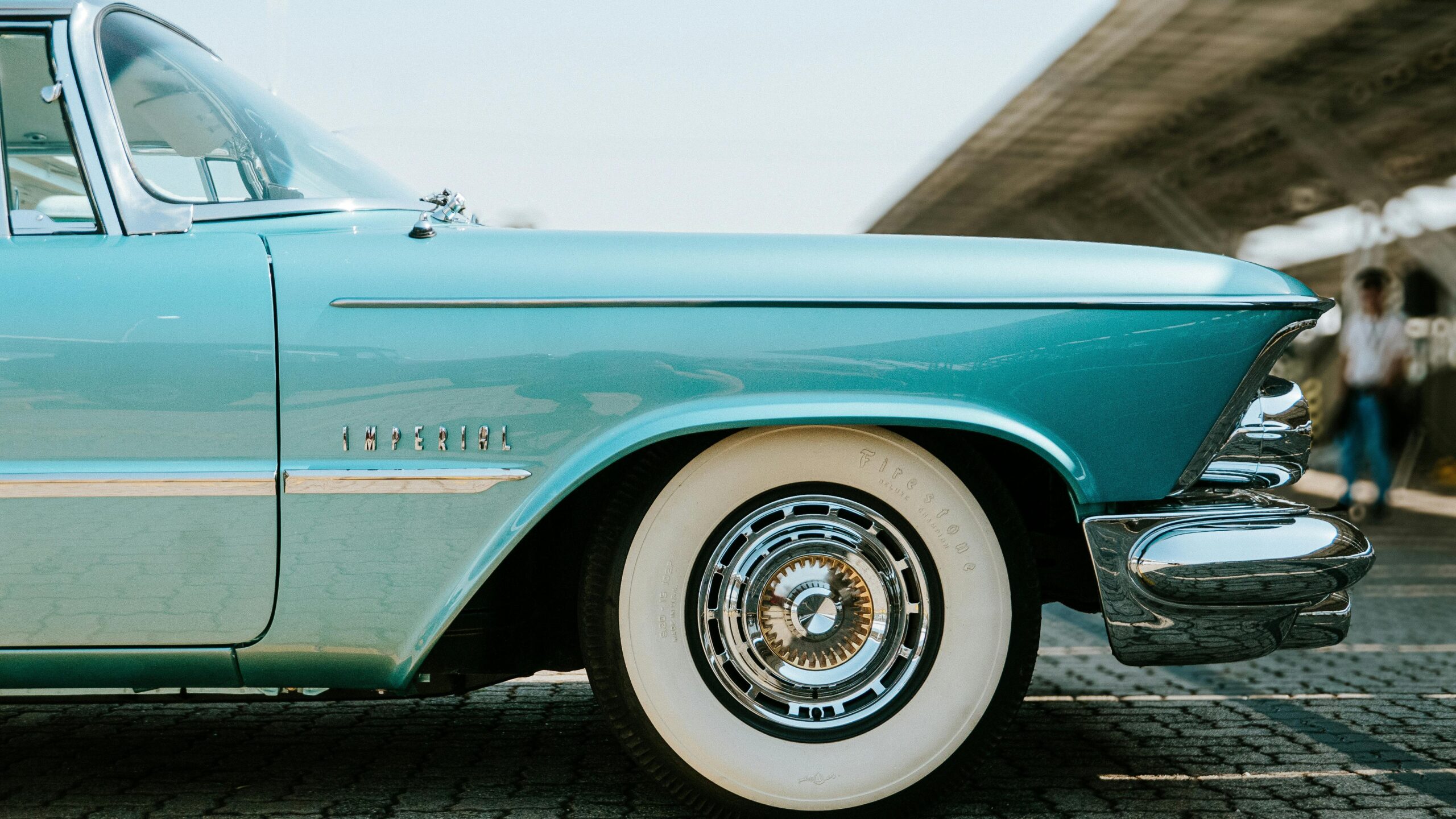 Close-up of a classic blue Chrysler Imperial car parked outdoors showcasing its elegant design.